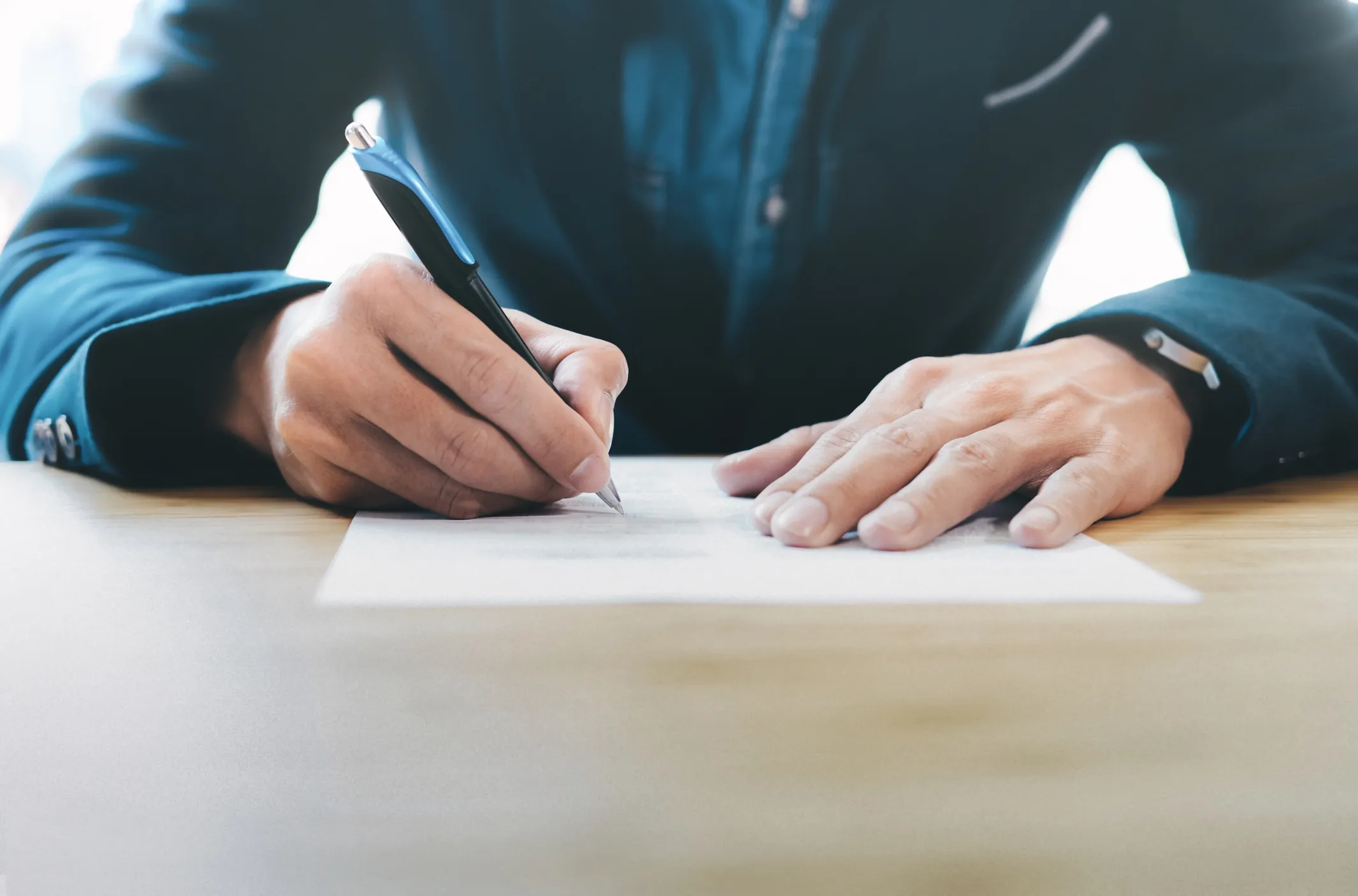 Person writing on a page