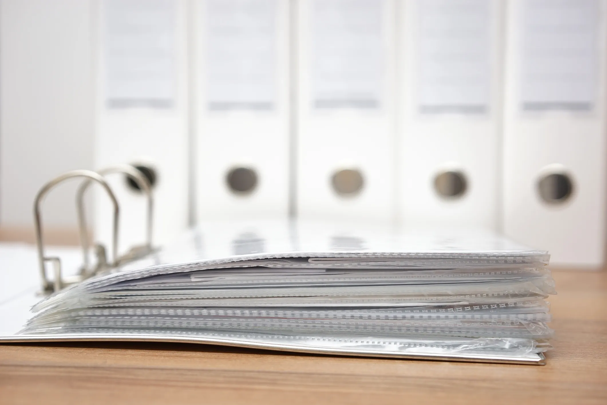 Stack of documents in an open ring binder